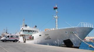 Ambulances are unloaded from a Kuwaiti ship in Tripoli on Sunday