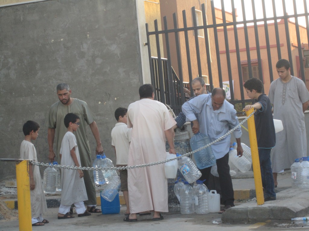 Tripoli residents filling empty bottles at a well outside a mosque today (Photo: Tom Westcott, Libya Herald)