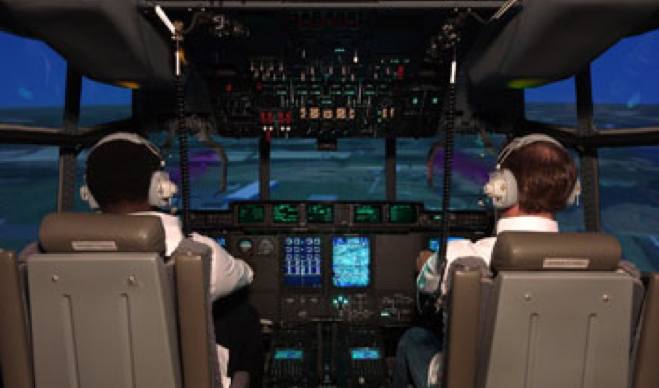 A pilot trying out a flight simulator for a C130J aircraft