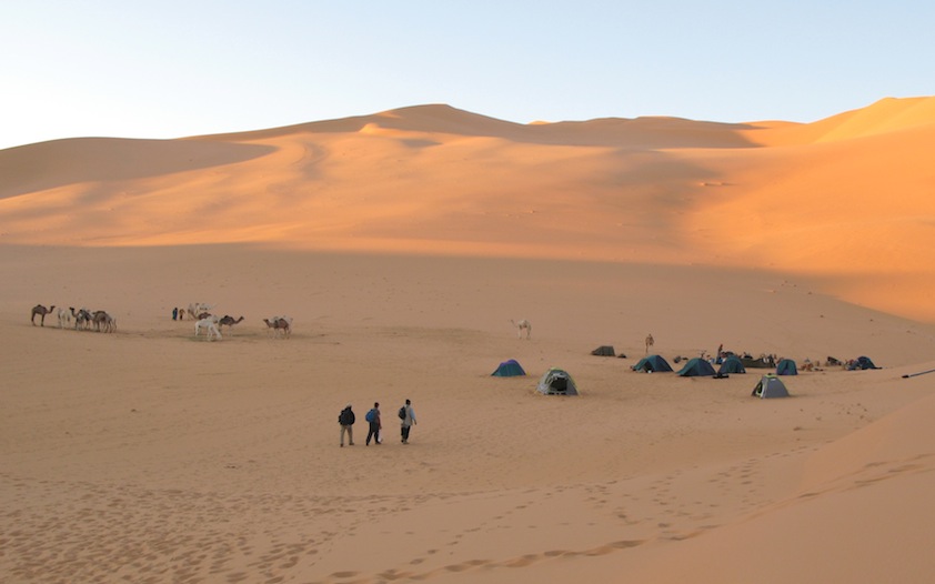 Figure 8: A fly camp for an international scientific expedition (Franco-Libyan Palaeontological Project) to the palaeolakes of Idhan Murzuk (2006), using camels.  A slow but practical way of exploring the remote areas within the dunes. This mode of transport could be utilised not only for scientific expeditions but also for adventure tourism to the exclusion of motorised vehicles. (Photo courtesy of MPFL Project.)