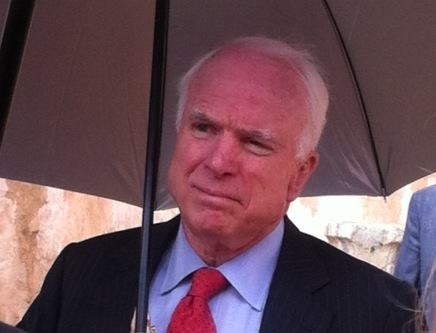 Senator John McCain sheltering from the rain this morning in Tripoli (Photo: Tom Westcott, Libya Herald)