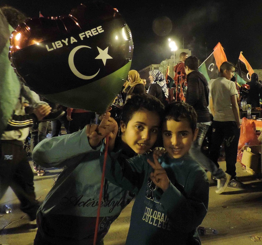 Two young boys celebrate with their family in Martyrs' Square (Photo: Callum Paton)