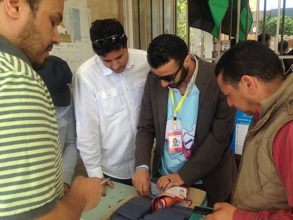 an official checks registration details at a Benghazi polling station (Photo: Aimen Amzein)