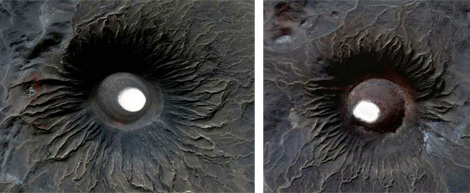 Almost identical volcanic cones in central al Haruj Al-Aswad. Typical radial drainage pattern signifies the uniformity of cone shape.  Sediments of fine sand and silt of fluvio-aeolean origin are in white in the centre of the . . .[restrict]cone.