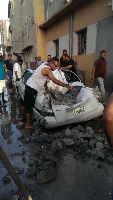 A missile hit a house and a car in the Chiesa (Church) district of Al-Hadba yesterday (Photo: Muftah Beleid).