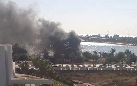 Burning wreckage of the deadly car bomb outside Benghazi's Tibesti Hotel