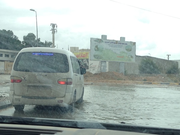 A Tripoli motorist gingerly approaches another flooded road 