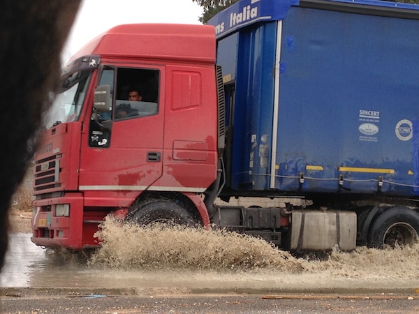 A lorry cruses with ease through muddy waters