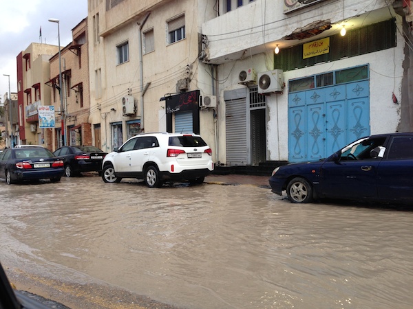 Motorists navigate a flooded street in Ben . . .[restrict]Ashour