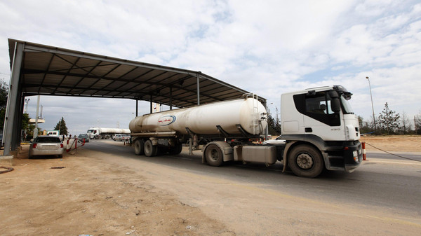 A tank truck exits from the main gate of the Zawiya refinery and oil port