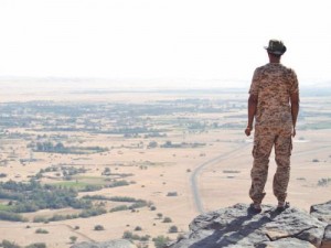 Militianman on mountain above Obari