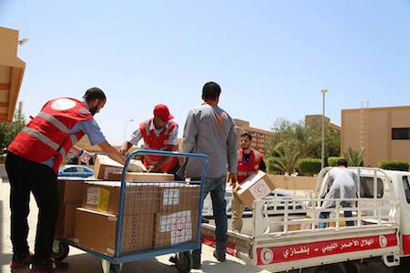 Red Crescent members unload boxes of supplies (Photo:  Red Crescent Society of Libya)