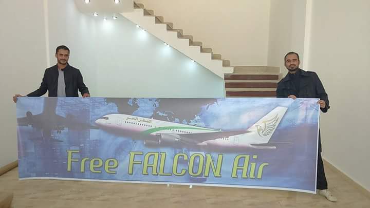 Staff at Free Falcon Air's Beida office with the new airline's poster (Photo: Free Falcon Air)