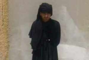 One of the arrested men still wearing his burqa (Photo: 501 Battalion)